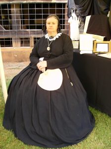 A woman reenactor wearing Victorian mourning gown