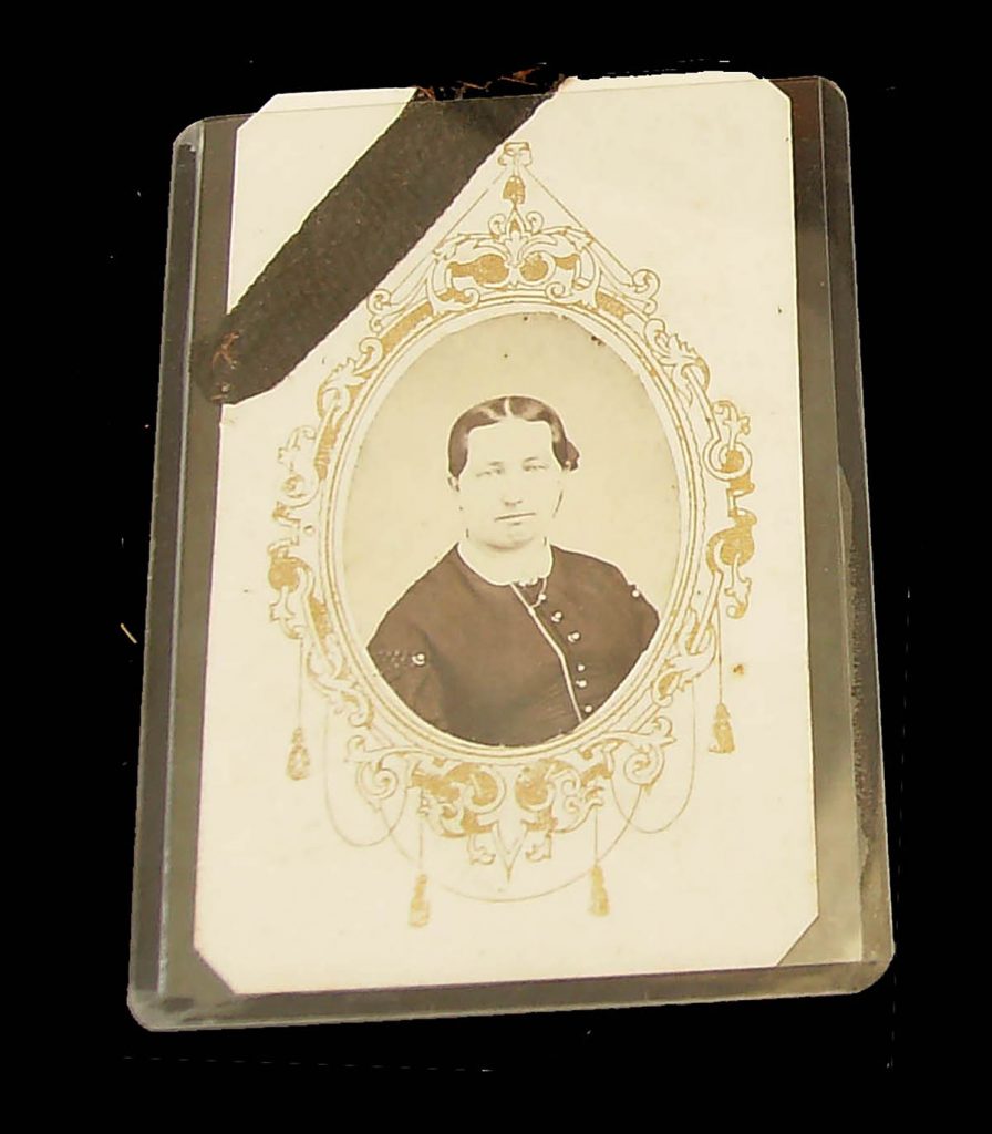 Victorian image of a loved one with a black ribbon across the top left to remember in mourning